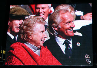 Greg Norman and Alice Dye as viewed on one of two giant screens while Pete Dye spoke at the 2008 World Golf Hall of Fame Induction Ceremony on 11/10/08.